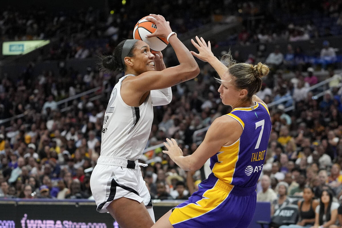 Las Vegas Aces center A'ja Wilson, left, shoots against Los Angeles Sparks forward Stephanie Ta ...