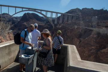 Tourists fill their water containers at the Hoover Dam Friday, July 5, 2024, in Boulder City. ( ...