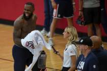 Los Angeles Lakers forward LeBron James laughs while exiting the court during training camp for ...