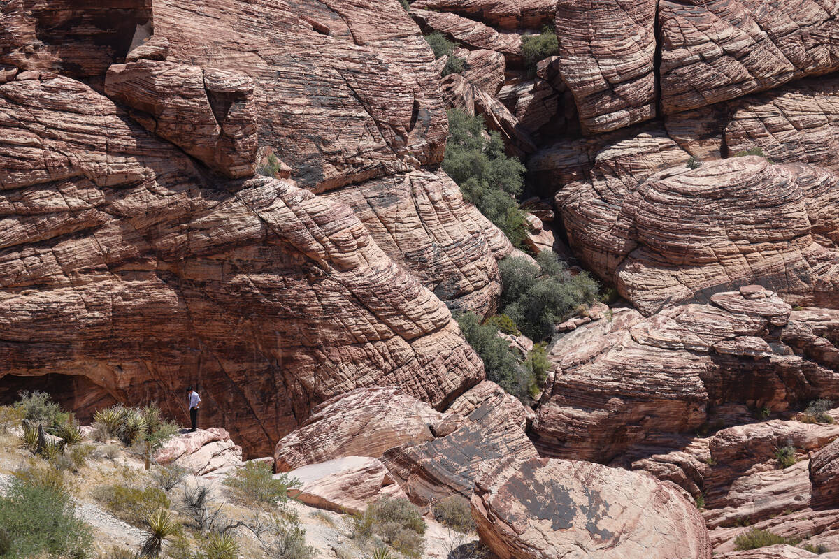 A person walks through rock formations at Red Rock Canyon National Conservation Area just outsi ...