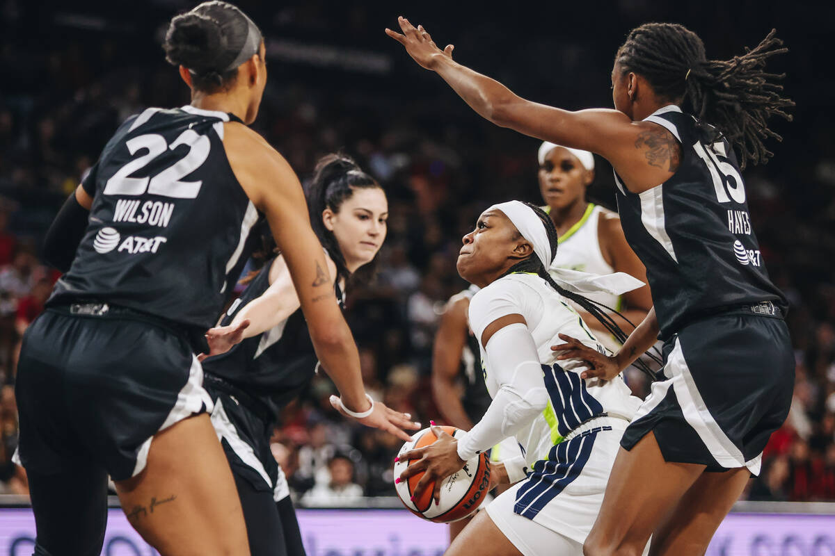 Dallas Wings guard Odyssey Sims (2) attempts to make a basket through the Aces’ defense ...