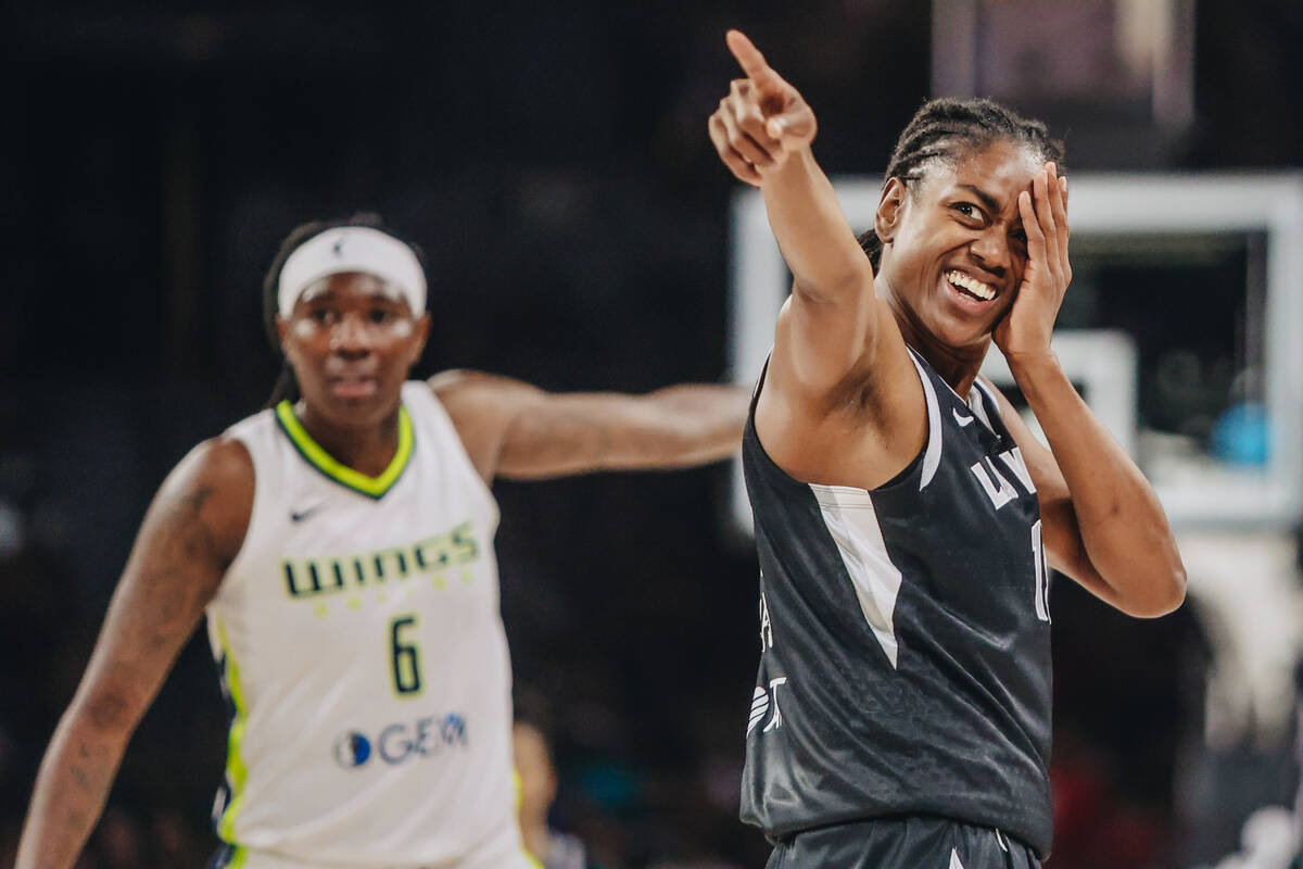 Aces guard Tiffany Hayes (15) holds her eye and points to Dallas Wings center Teaira McCowan (o ...