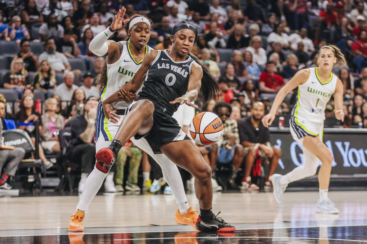 Aces guard Jackie Young (0) chases the ball during a WNBA basketball game between the Aces and ...