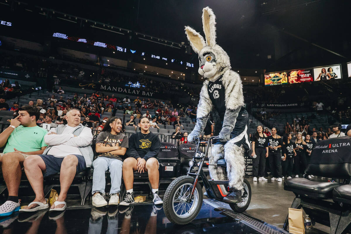 Aces mascot Buckets rides a bike onto the court during a WNBA basketball game between the Aces ...