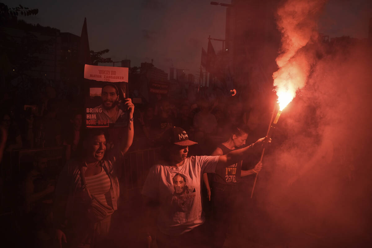 People attend a protest marking nine months since the start of the war and calling for the rele ...