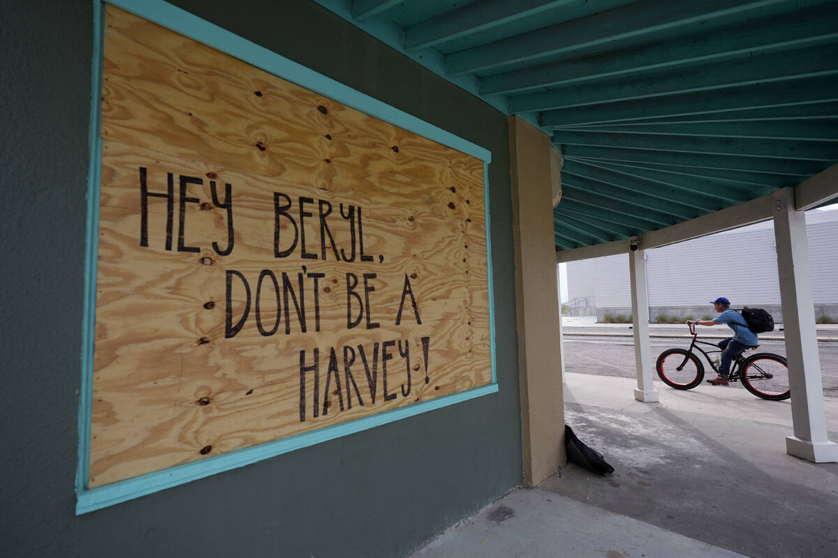 A message for Beryl is left on a boarded up business, Sunday, July 7, 2024, in Rock Port, Texas ...