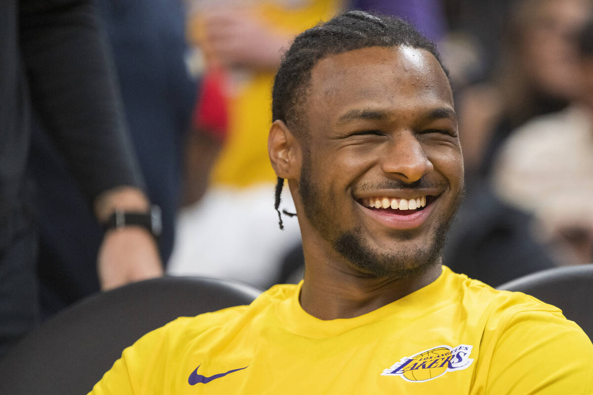 Los Angeles Lakers guard Bronny James laughs before an NBA summer league basketball game agains ...