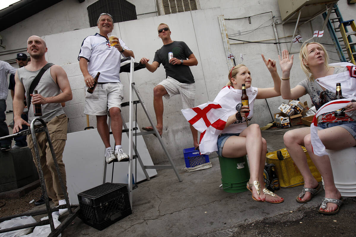 Part of the overflow crowd of soccer fans watch televised World Cup 2010 coverage of a match be ...