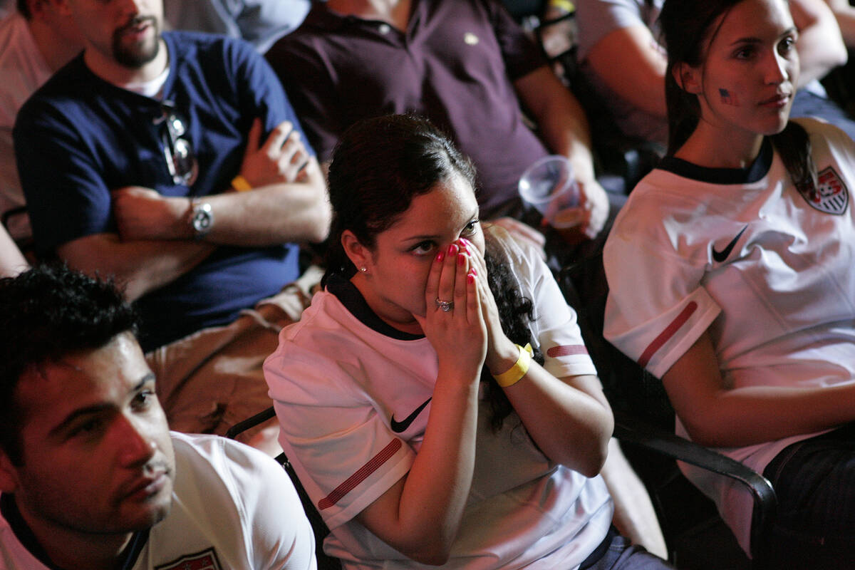 Gerri Melgar, center, reacts while watching televised coverage at the Crown & Anchor Britis ...