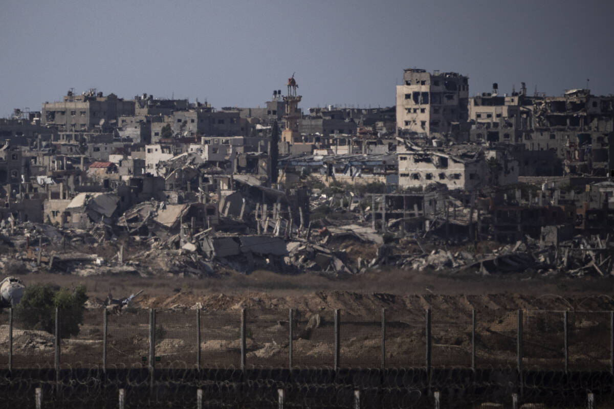 Destroyed buildings stand in the Gaza Strip, as seen from southern Israel, Monday, July 8, 2024 ...