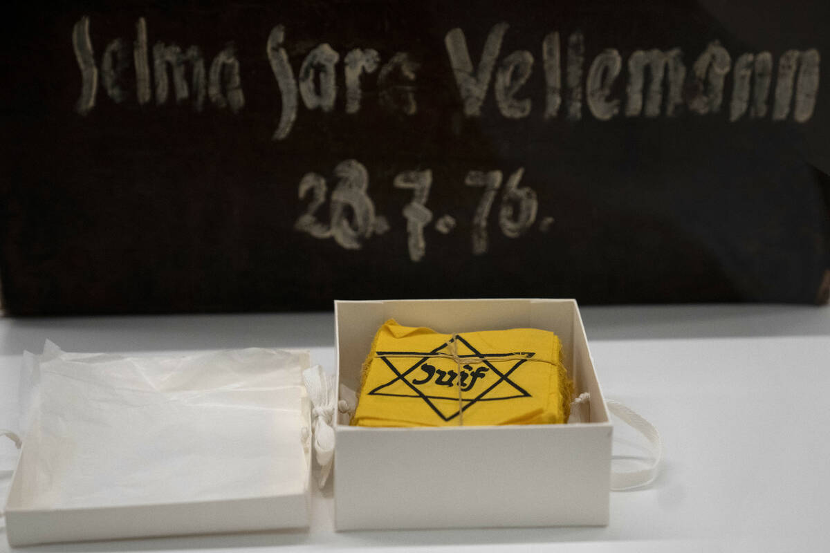 Yellow badges and a piece of luggage are displayed during the inauguration of The Moshal Shoah ...