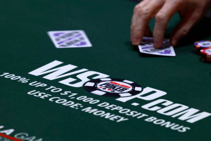 A poker player participates during the first day of the World Series of Poker Main Event at Hor ...