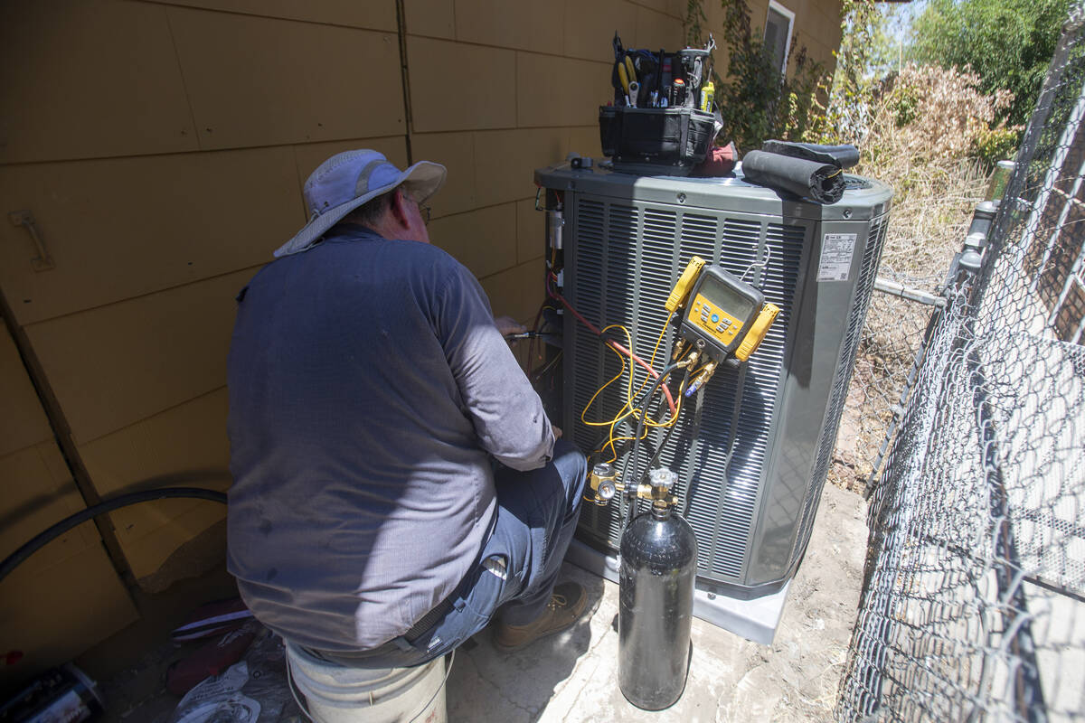 Steve Kendrick installs a new HVAC unit at Kit Herron’s home Friday, July 5, 2024, in Las Veg ...