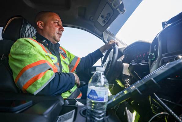Stephen SanFilippo, supervisor for the Freeway Service Patrol, talks on his radio while drivin ...