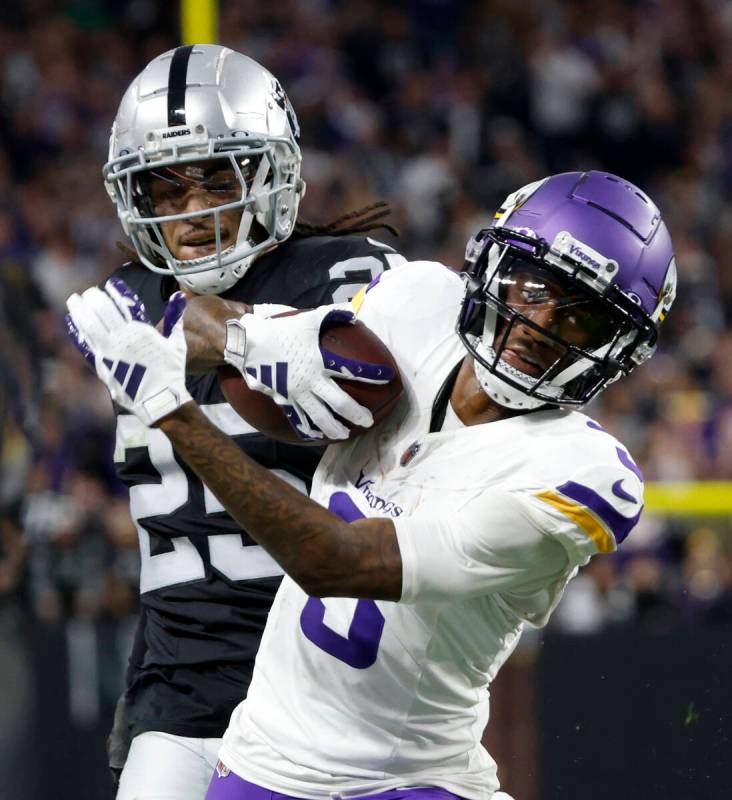 Minnesota Vikings wide receiver Jordan Addison (3) runs past Raiders safety Tre'von Moehrig (25 ...