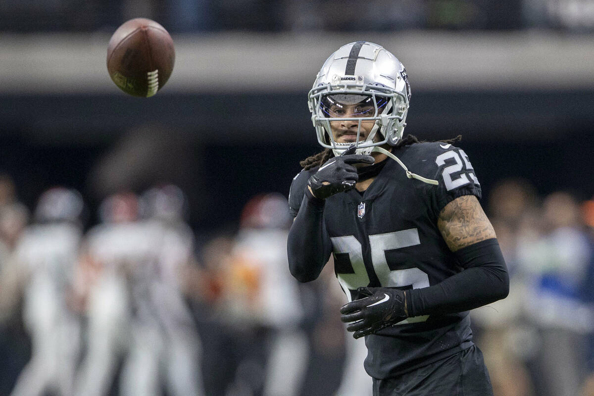 Raiders safety Tre'von Moehrig (25) throws the football during team warm-ups before an NFL game ...