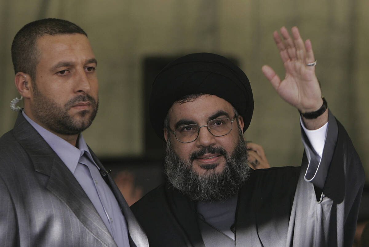 FILE - Hezbollah leader Sayyed Hassan Nasrallah, right, escorted by his bodyguard Yasser Nemr Q ...