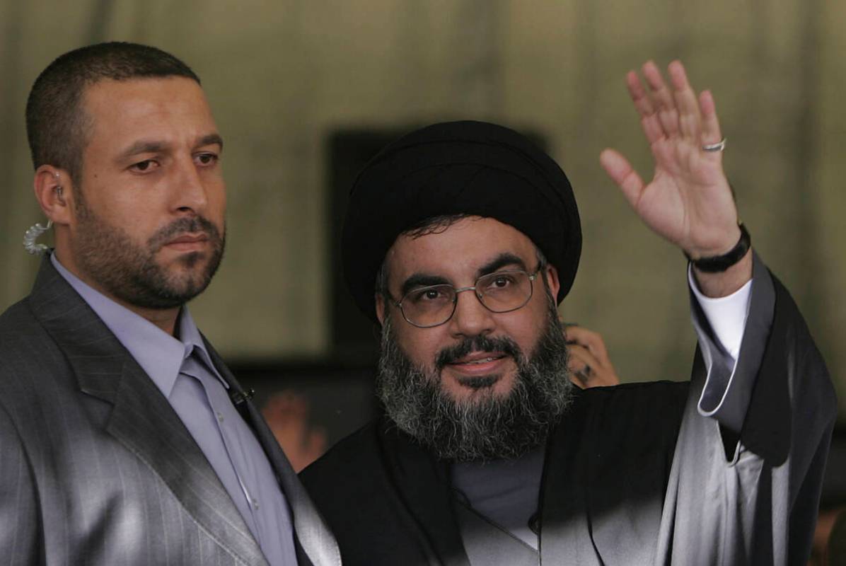 FILE - Hezbollah leader Sayyed Hassan Nasrallah, right, escorted by his bodyguard Yasser Nemr Q ...