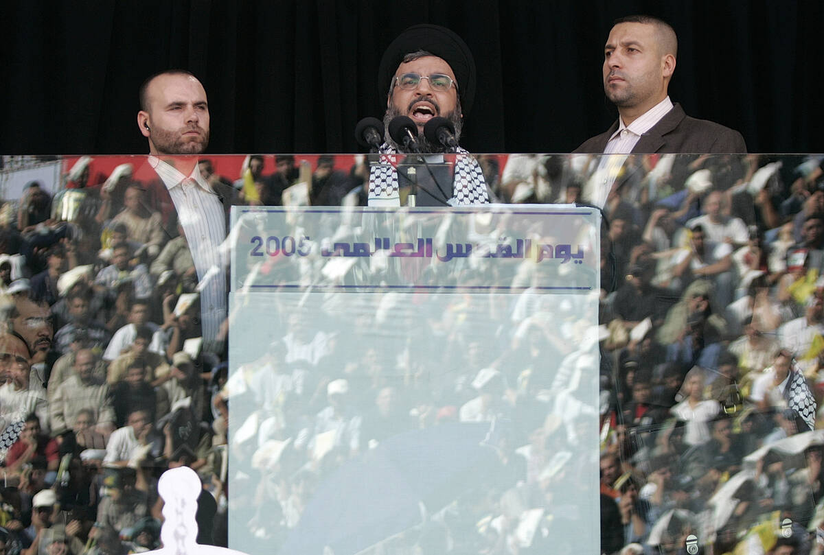 FILE - Hezbollah leader Sayyed Hassan Nasrallah, center, escorted by his bodyguard Yasser Nemr ...