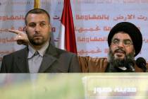 FILE - Hezbollah leader Sayyed Hassan Nasrallah, right, gives an address while accompanied by h ...