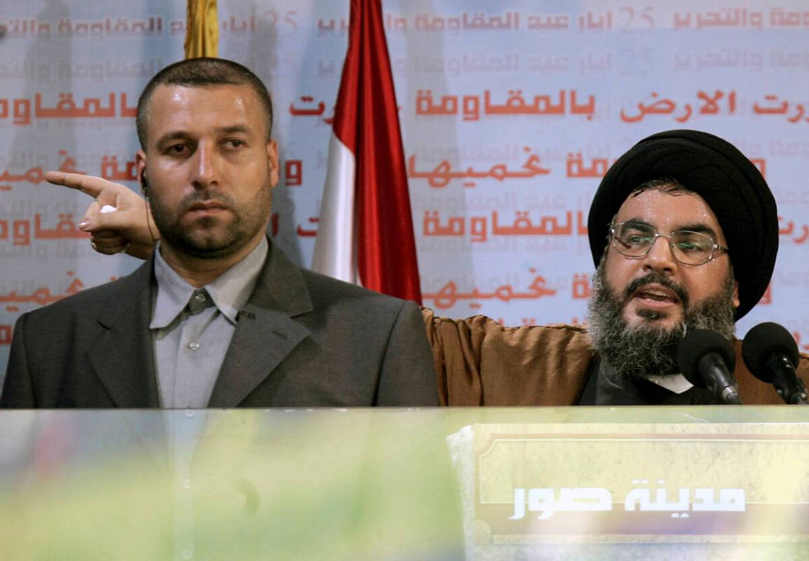 FILE - Hezbollah leader Sayyed Hassan Nasrallah, right, gives an address while accompanied by h ...