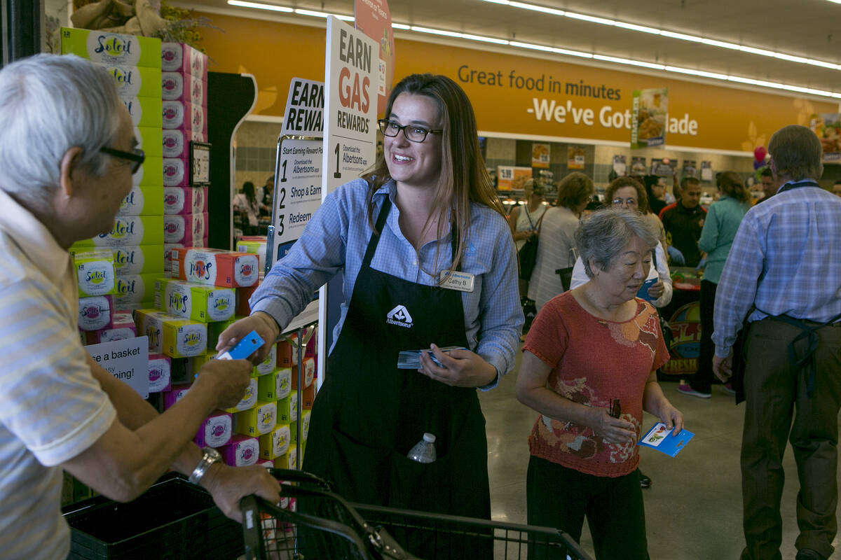 Customer service manager Cathy Budginas greets patrons as they enter during the grand opening o ...