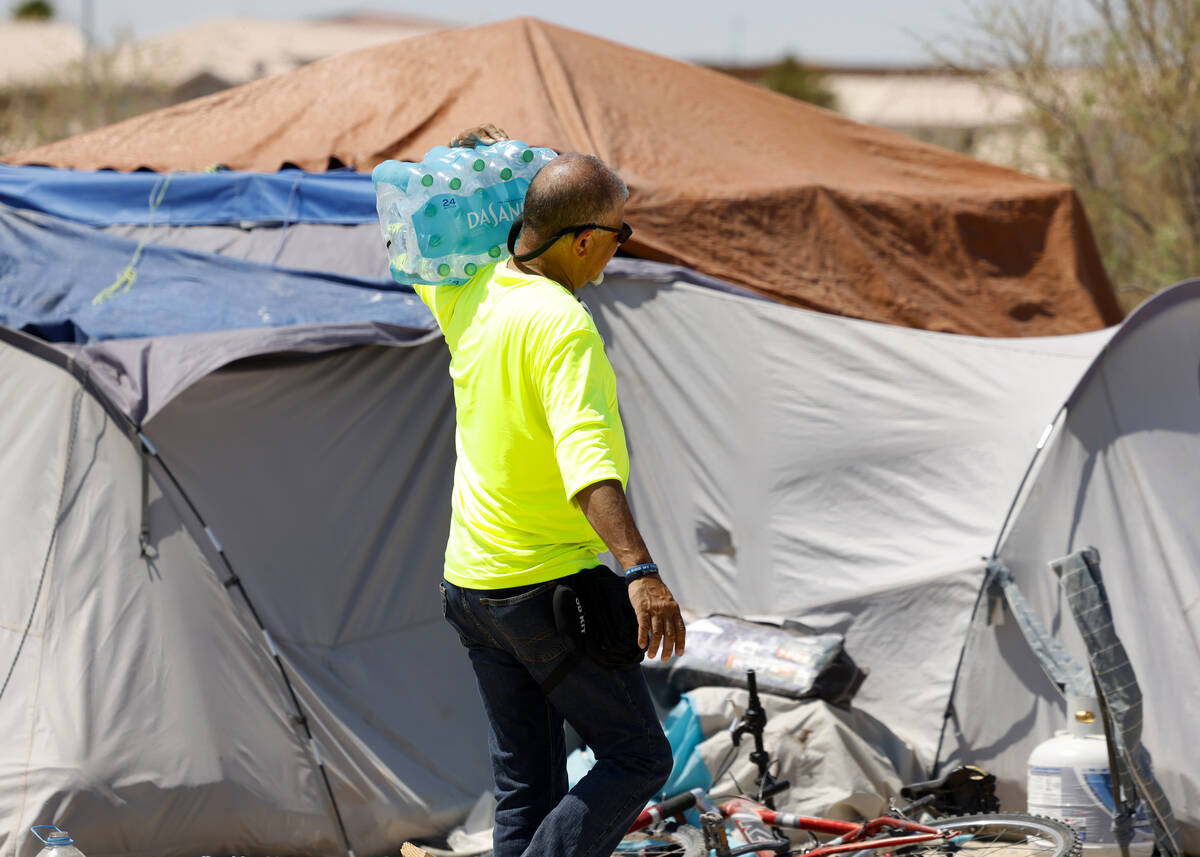 Louis Lacey, director of Homeless Response Teams at Help Of Southern Nevada, delivers a case of ...