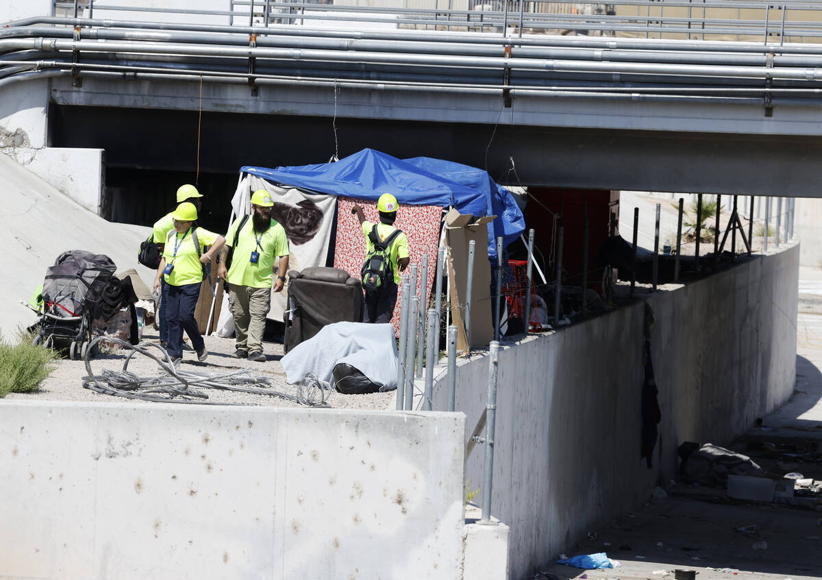 A Help of Southern Nevada outreach workers check out homeless encampment at Mountain Vista Stre ...