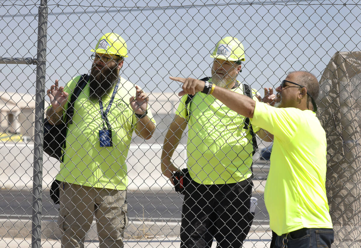 Richard Lopez, left, a Help of Southern Nevada Homeless Response Team lead, Chris Engel, center ...