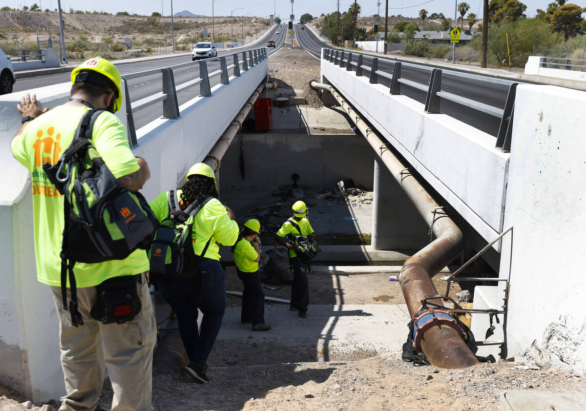 Help of Southern Nevada outreach workers check out homeless encampments at Mountain Vista Stree ...