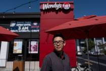 Lawrence Cheng, whose family owns seven Wendy's locations south of Los Angeles, stands for a ph ...