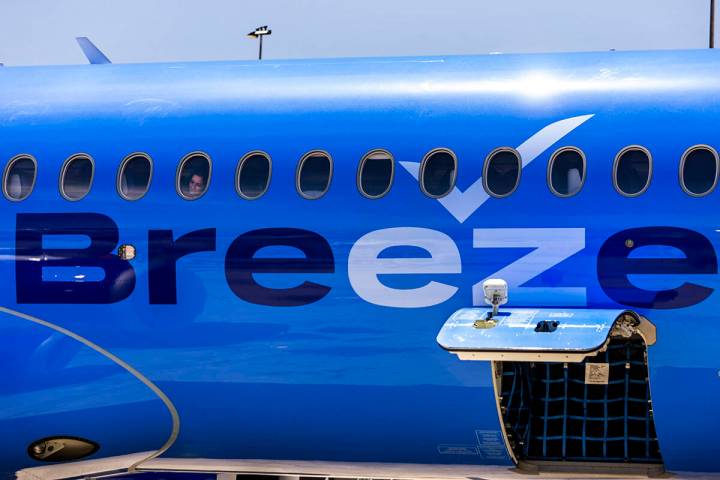 A Breeze Airways passenger looks out the window as their inaugural flight arrival makes it to t ...