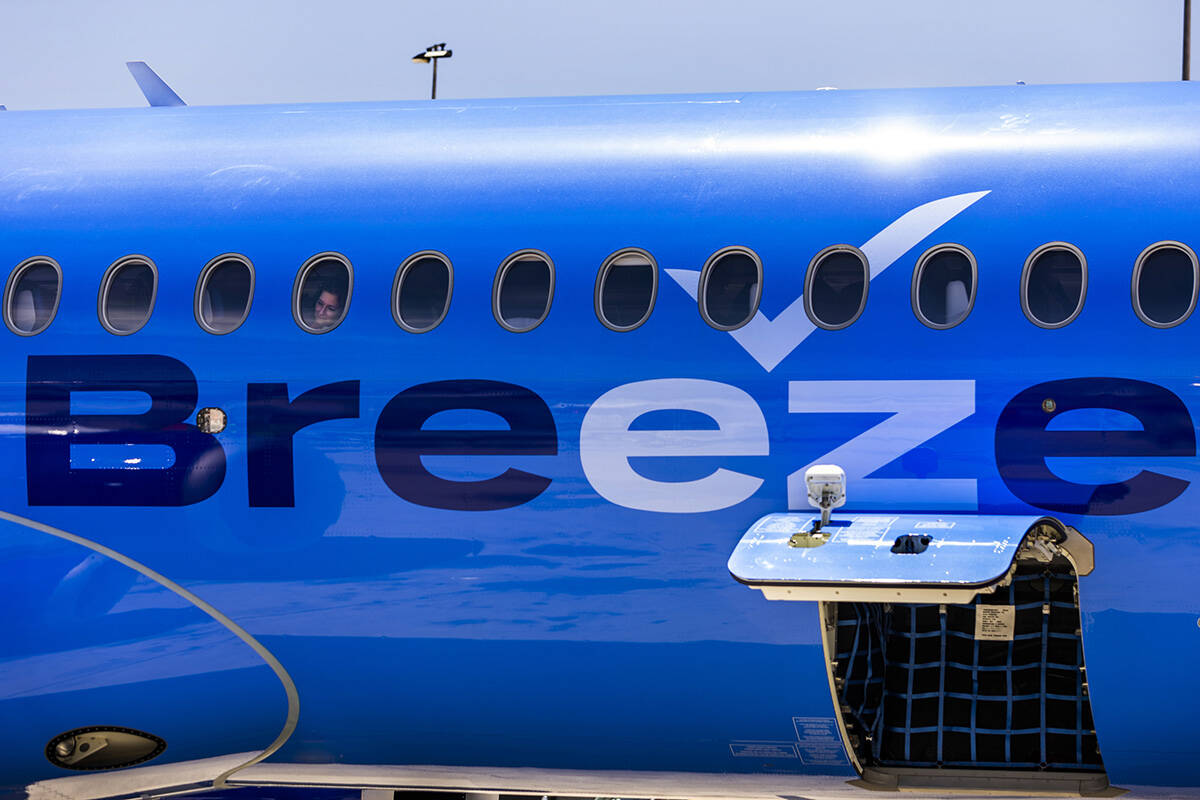 A Breeze Airways passenger looks out the window as their inaugural flight arrival makes it to t ...