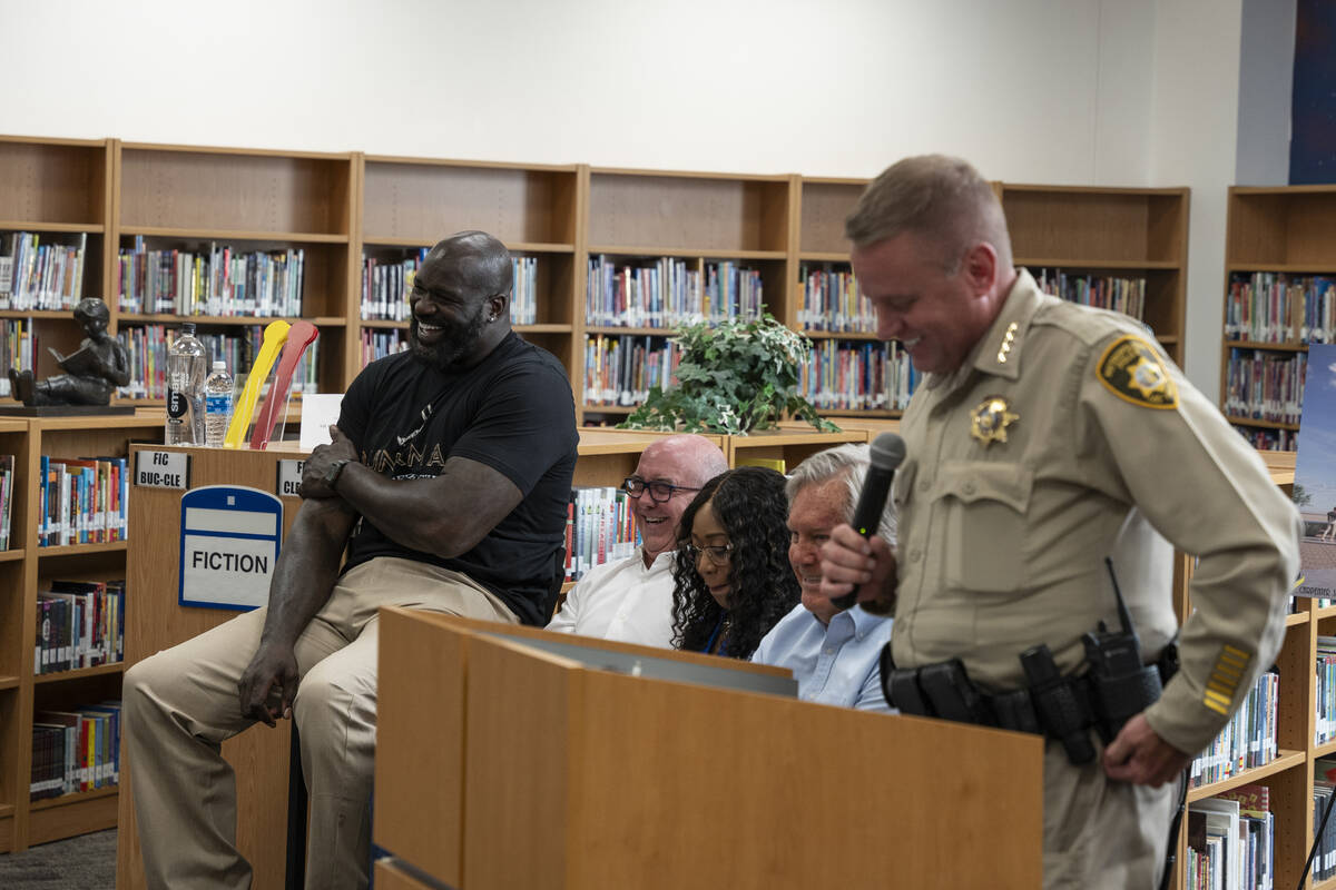 Shaquille O'Neal, left, laughs with Sheriff Kevin McMahill, right, during a press conference at ...