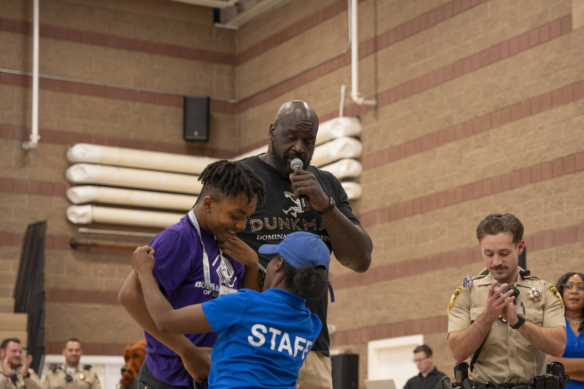 Shaquille O'Neal rewards a member of the Boys & Girls Club for having the best dance moves ...