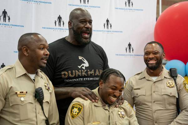 Shaquille O'Neal jokes with LVMPD officers at the Shaq-to-School event in the Mario C. & Jo ...
