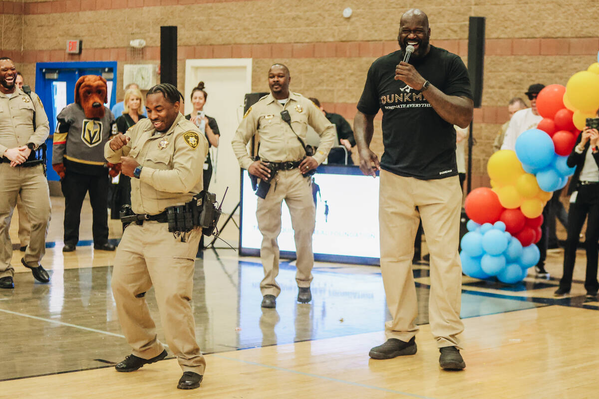 Shaquille O’Neal makes a police officer dance during a press conference at the Shaq-to-S ...