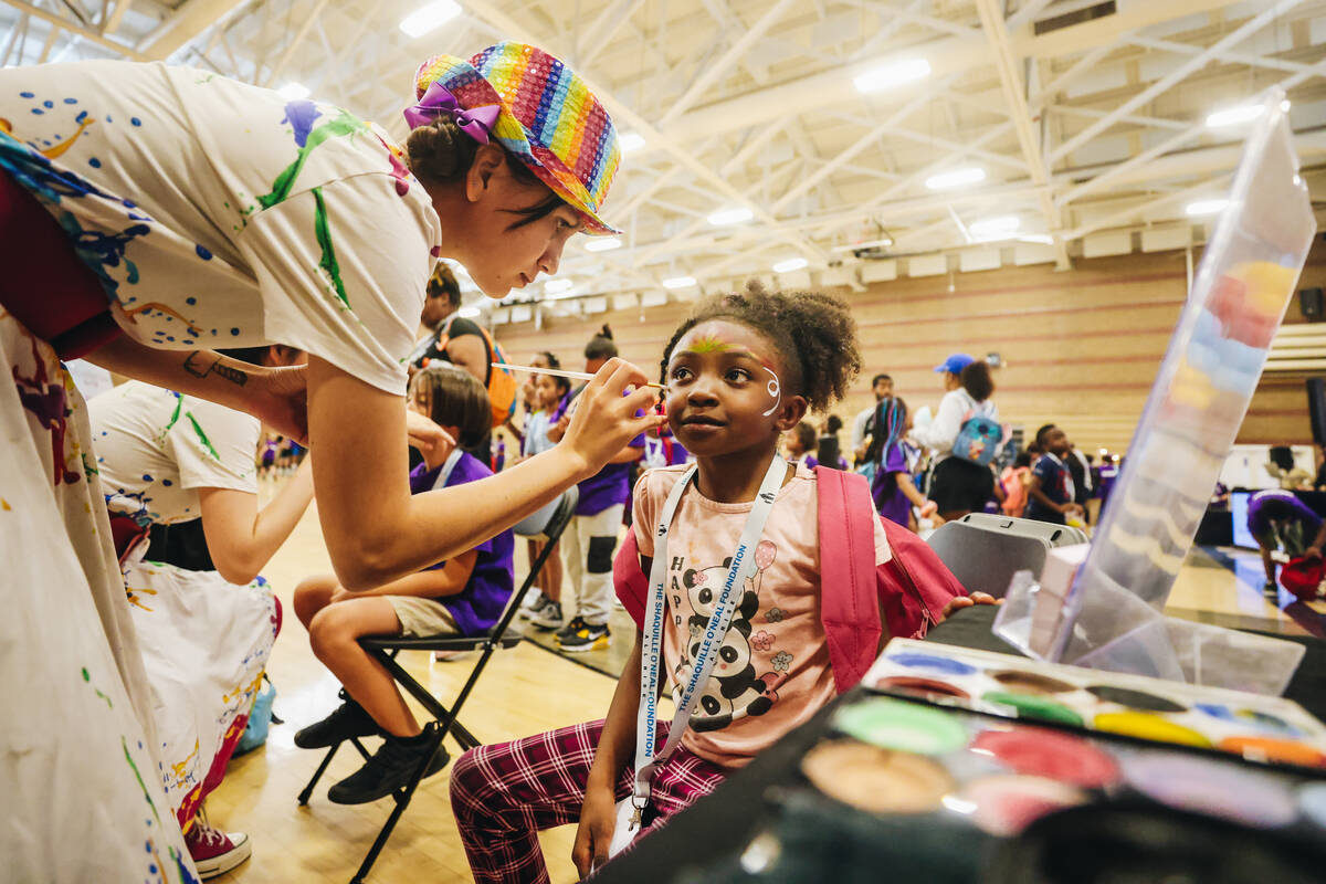 Jalaya McDowel, 6, gets her face painted during the Shaq-to-School event at Mario C. & Joan ...