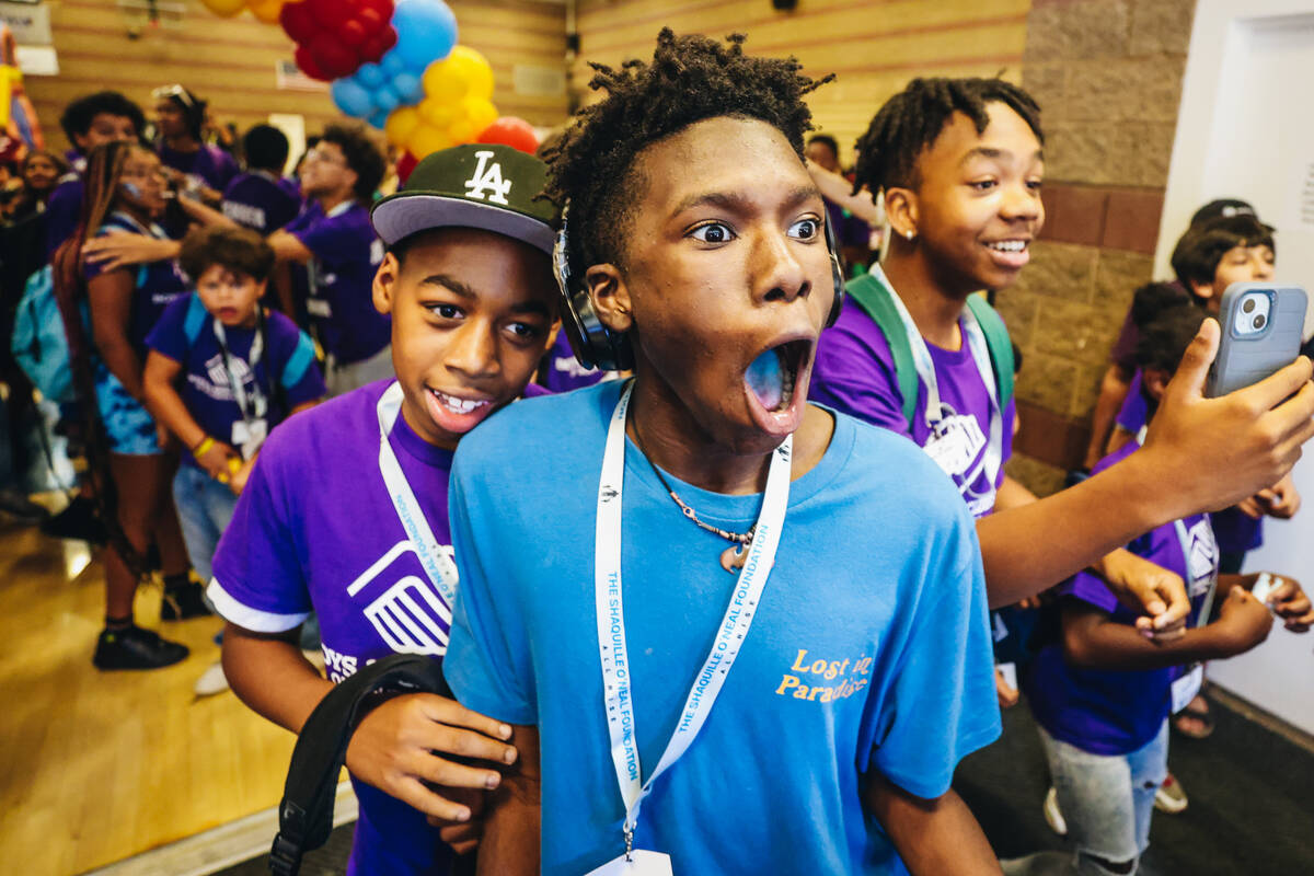 Members of the Boys & Girls Club react to seeing Shaquille O’Neal walking towards th ...