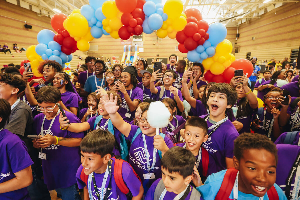 Members of the Boys & Girls Club react to seeing Shaquille O’Neal walking towards th ...