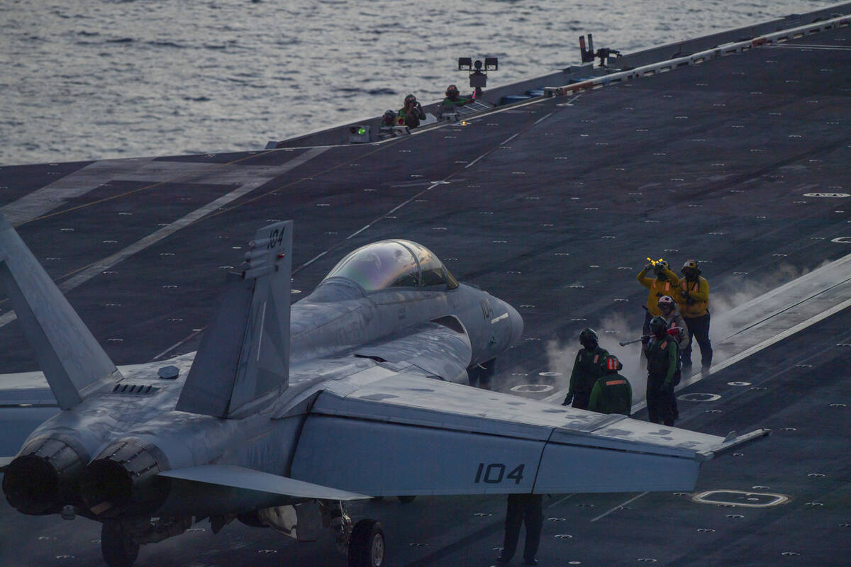 In this photograph released by the U.S. Navy, an F/A-18 Super Hornet prepares to launch off the ...