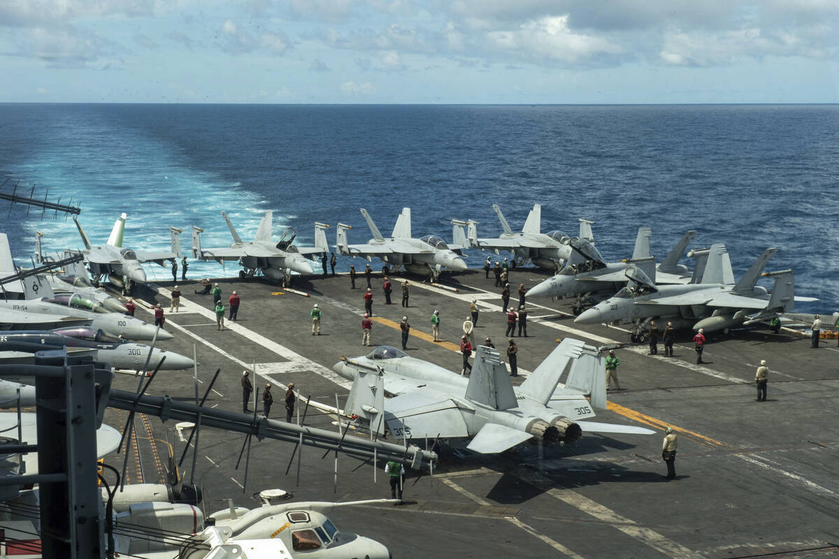 In this photograph released by the U.S. Navy, the flight deck of the Nimitz-class aircraft carr ...