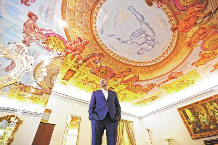 Martyn Ravenhill, owner of the Liberace Mansion, stands in the master bedroom featuring a recre ...