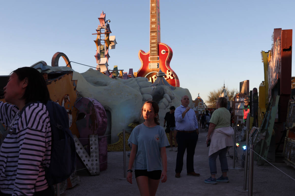 Visitors of the Neon Museum wander through the historic signs on Wednesday, April 3, 2024, in L ...