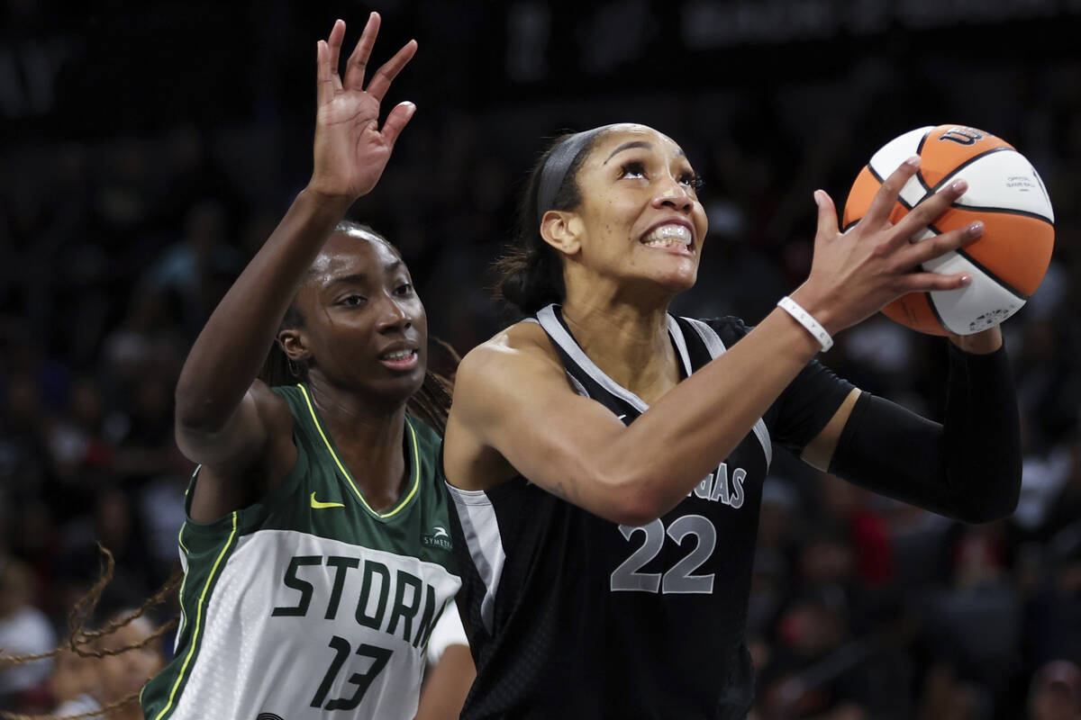 Las Vegas Aces center A'ja Wilson (22) shoots in front of Seattle Storm center Ezi Magbegor (13 ...