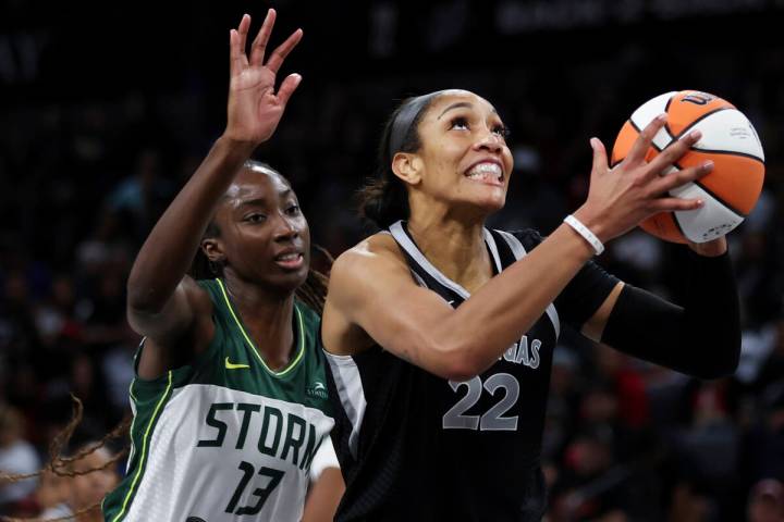 Las Vegas Aces center A'ja Wilson (22) shoots in front of Seattle Storm center Ezi Magbegor (13 ...