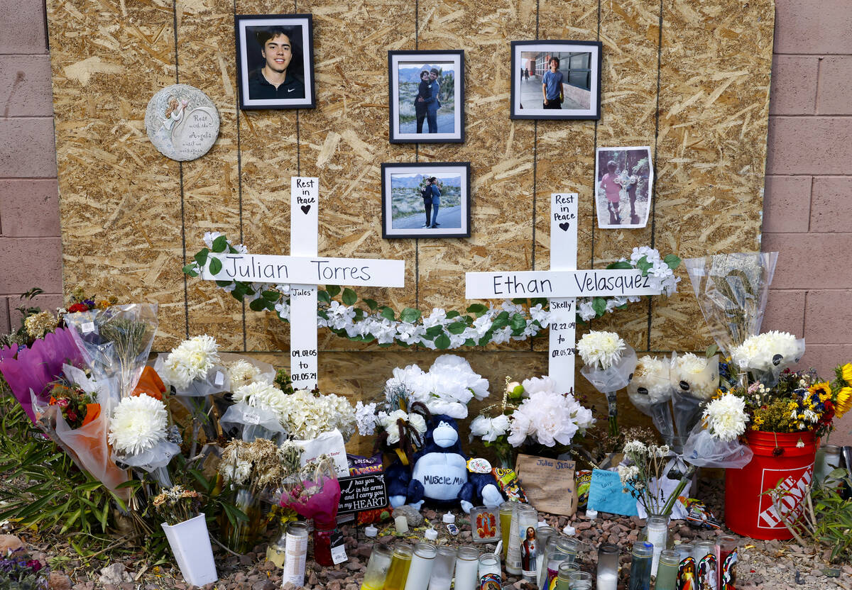 Photographs of Julian Torres, left, and Ethan Velasquez, are displayed at a makeshift memorial ...