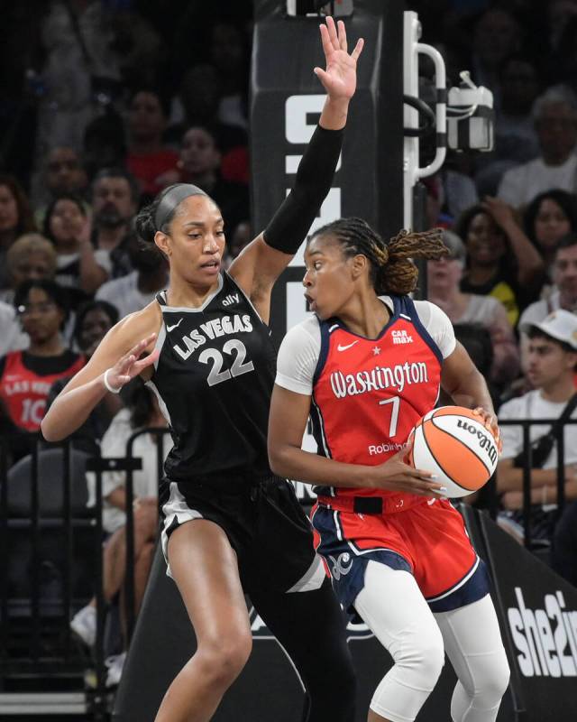 Las Vegas Aces center A'ja Wilson (22) defends Washington Mystics guard Ariel Atkins (7) during ...