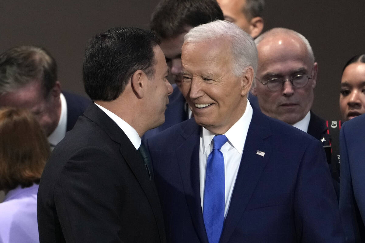 Portuguese Prime Minister Luis Montenegro, left, speaks with President Joe Biden at Working Ses ...