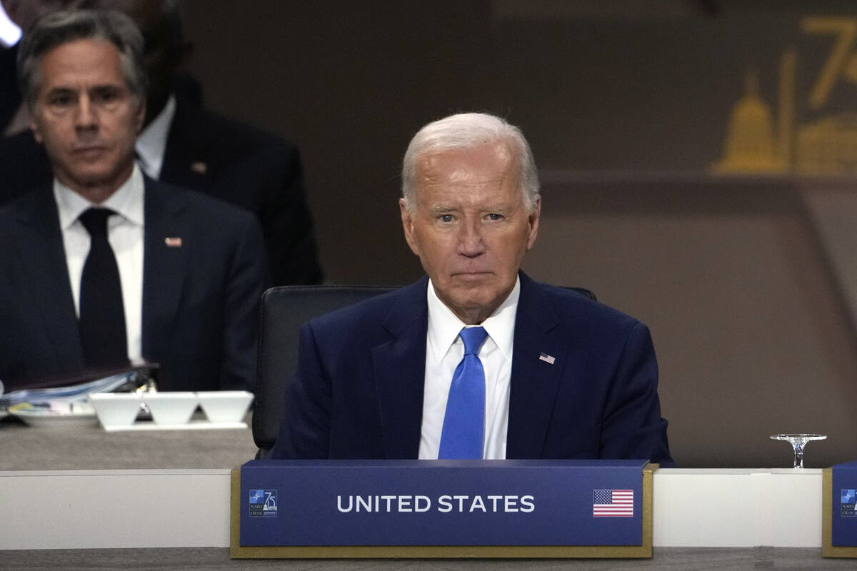 President Joe Biden sits as Secretary of State Antony Blinken, left, looks on during Working Se ...